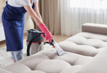 Person using Bissell Spot Clean on carpet stain in modern living room