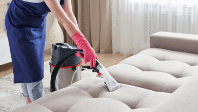 Person using Bissell Spot Clean on carpet stain in modern living room